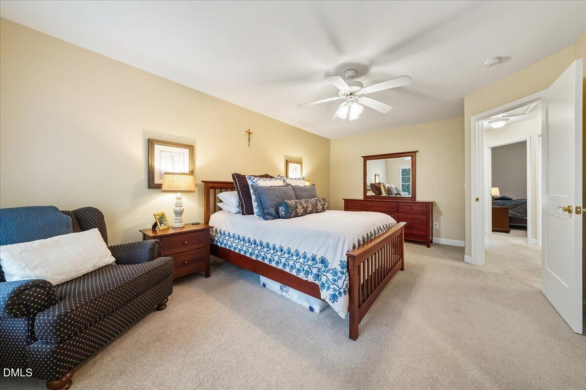 617 Rodney Bay Crossing Wake Forest, NC 27587 - Photo 20 of 36 a bedroom with a bed couch and window