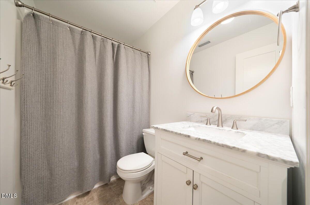 617 Rodney Bay Crossing Wake Forest, NC 27587 - Photo 24 of 36 a bathroom with a granite countertop sink and a mirror