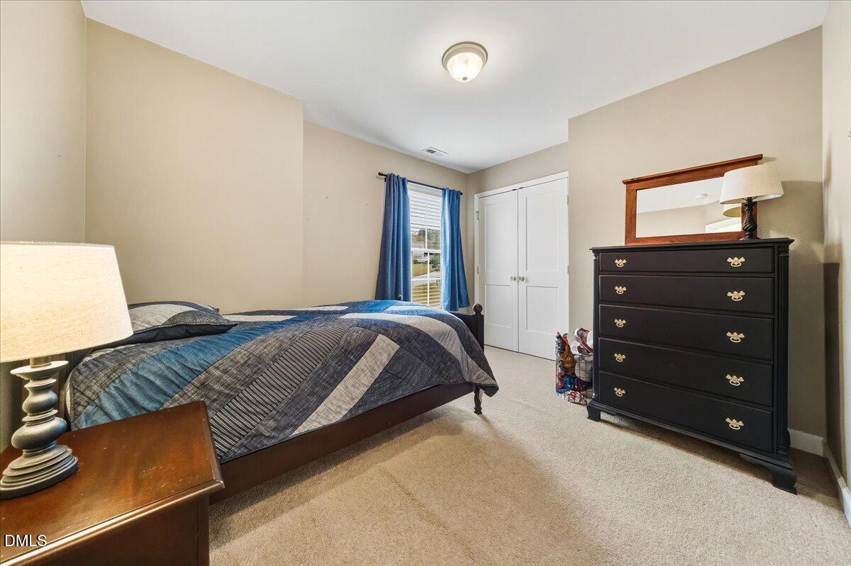 617 Rodney Bay Crossing Wake Forest, NC 27587 - Photo 25 of 36 a bedroom with a bed and a television