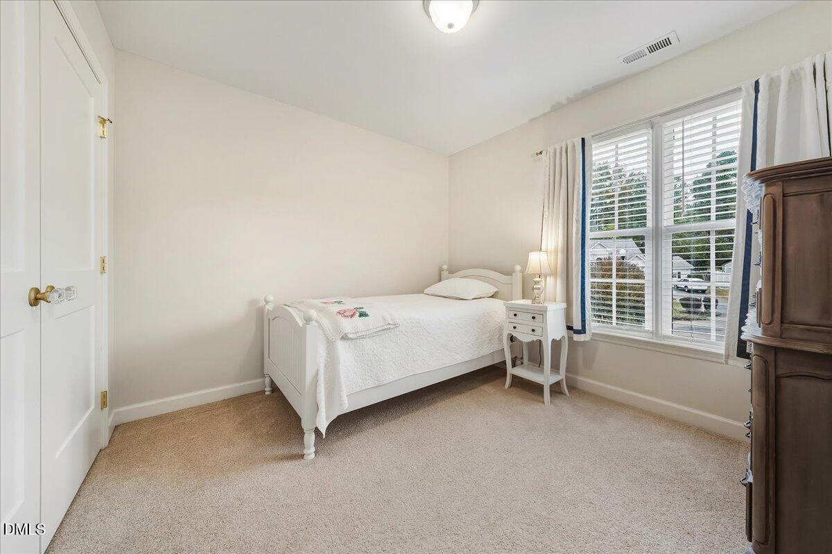 617 Rodney Bay Crossing Wake Forest, NC 27587 - Photo 26 of 36 a bed room with a bed and a chair