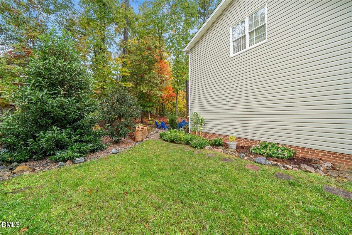 617 Rodney Bay Crossing Wake Forest, NC 27587 - Photo 29 of 36 a view of a backyard with plants and large trees