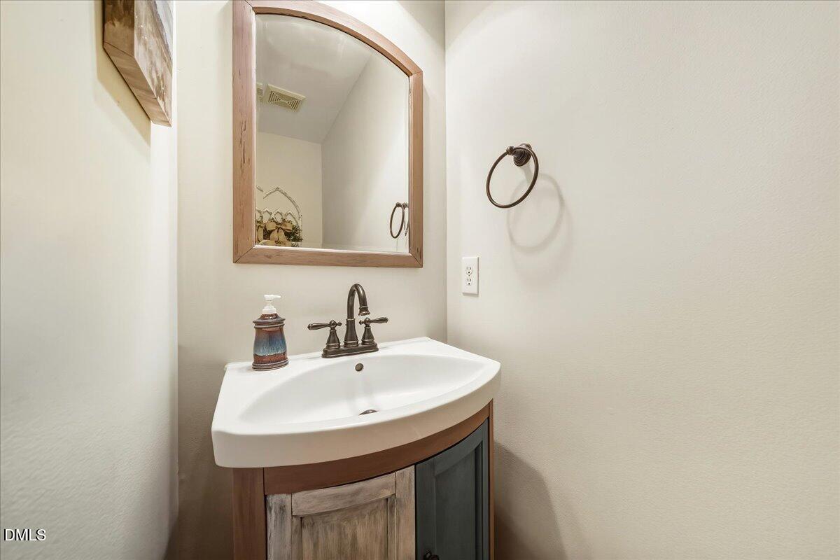 617 Rodney Bay Crossing Wake Forest, NC 27587 - Photo 6 of 36 a bathroom with a sink and a mirror