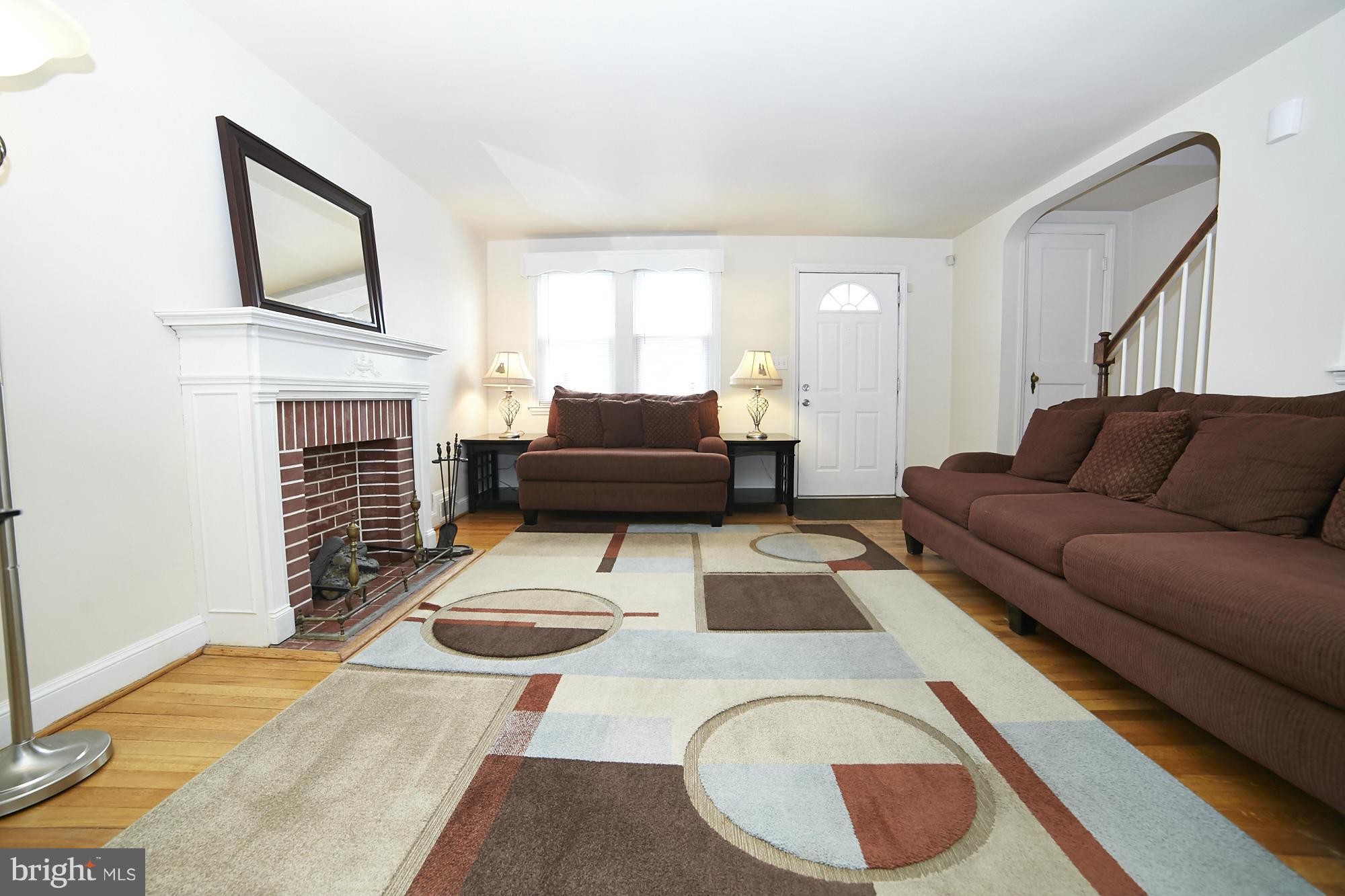 4936 West Hills Road Baltimore, MD 21229 - Photo 2 of 18 a living room with furniture and a fireplace