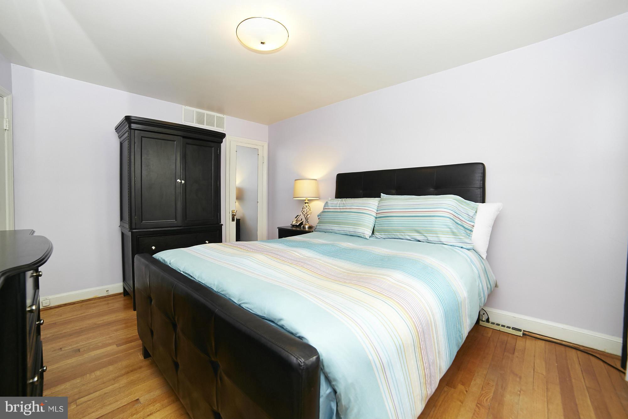 4936 West Hills Road Baltimore, MD 21229 - Photo 11 of 18 a bedroom with a bed and a table