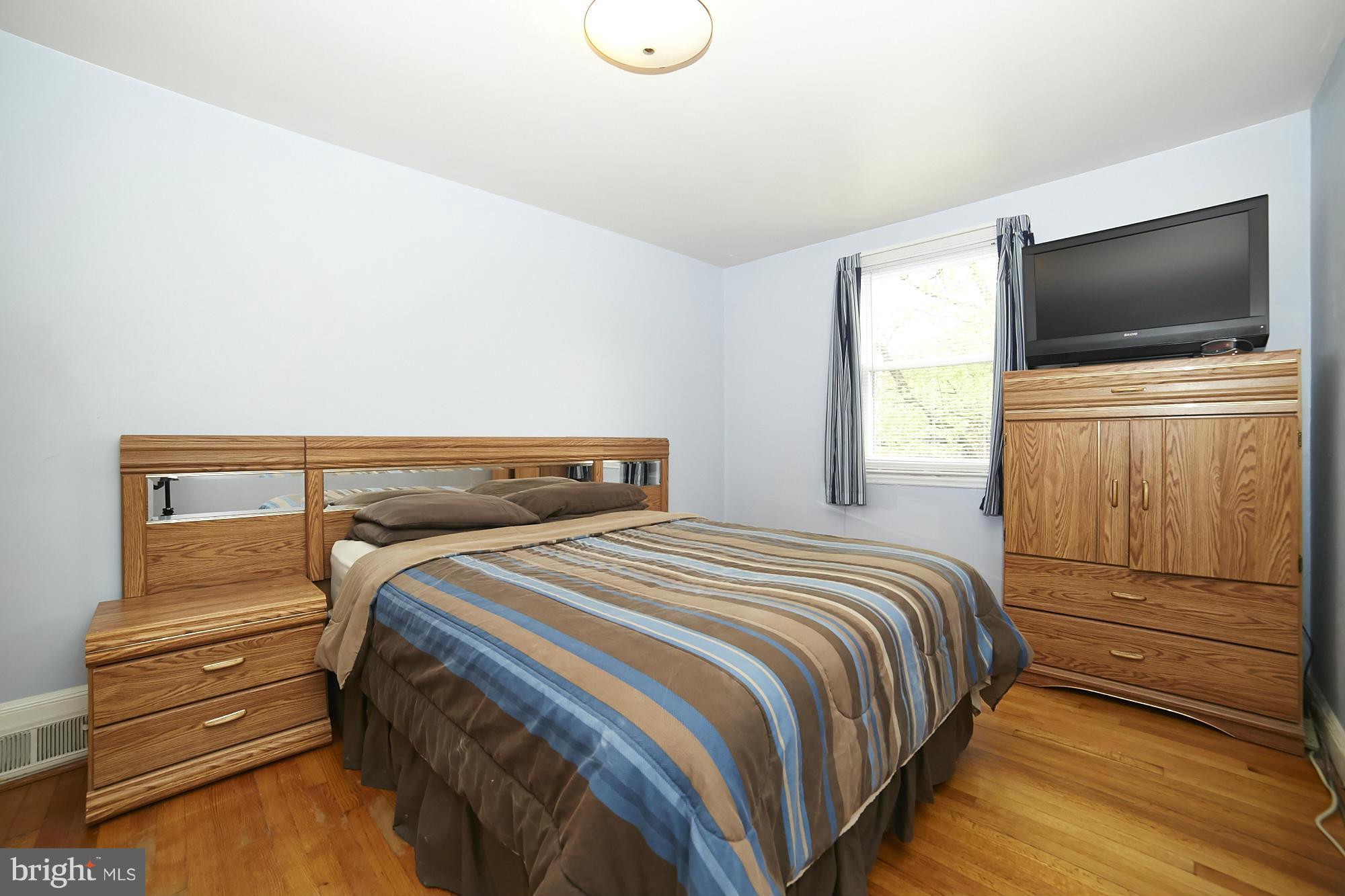 4936 West Hills Road Baltimore, MD 21229 - Photo 13 of 18 a bedroom with a bed and a flat screen tv