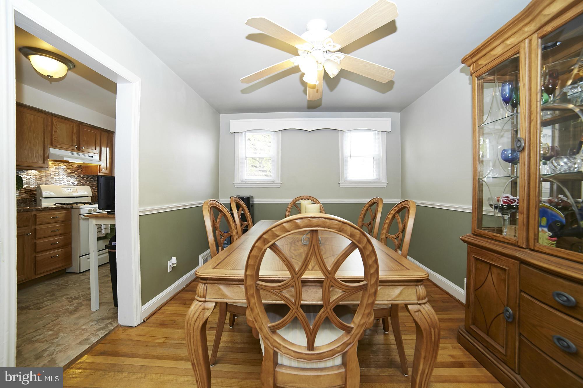 4936 West Hills Road Baltimore, MD 21229 - Photo 4 of 18 a view of a dining room with furniture window and wooden floor