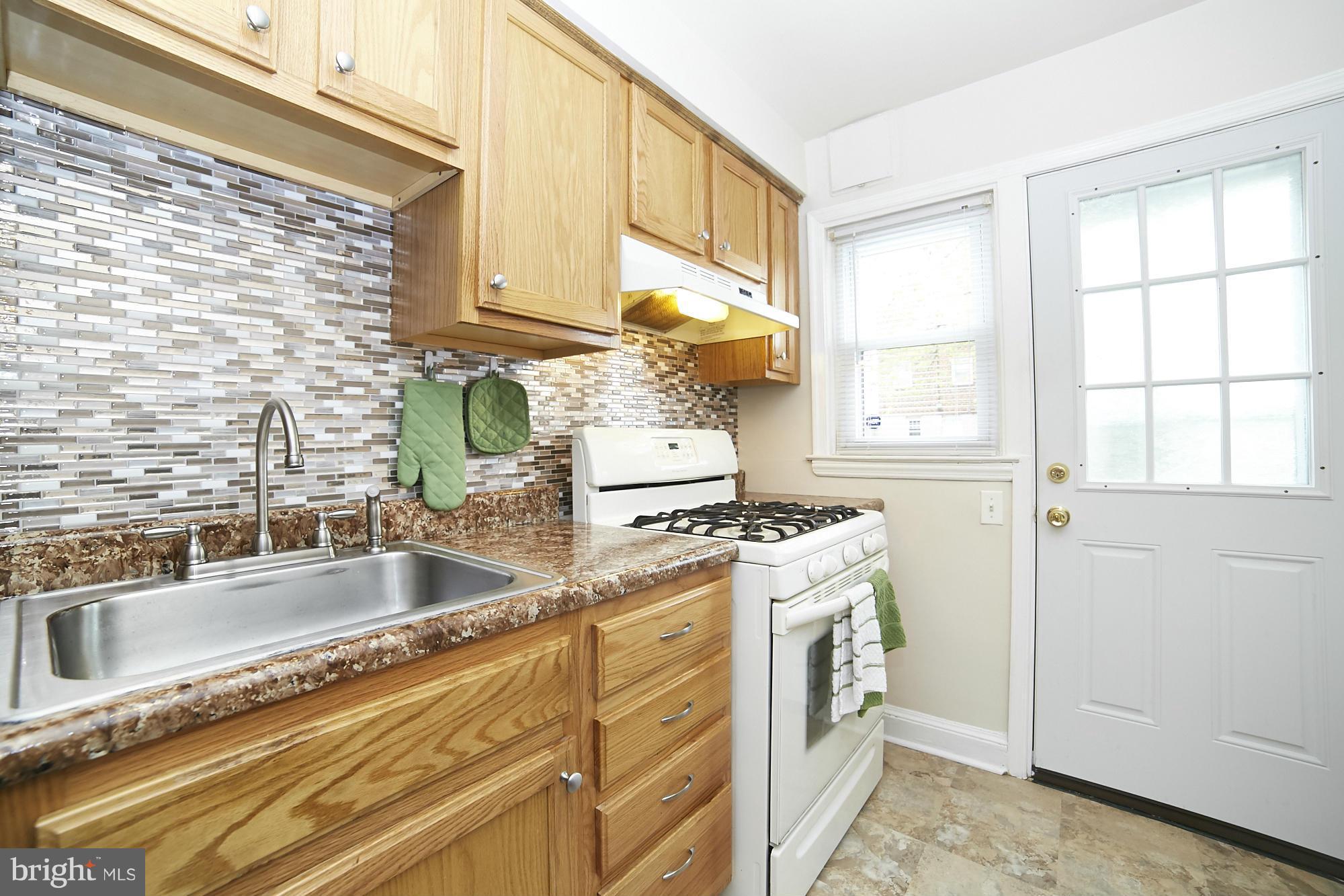 4936 West Hills Road Baltimore, MD 21229 - Photo 8 of 18 a kitchen with stainless steel appliances granite countertop a sink stove and cabinets