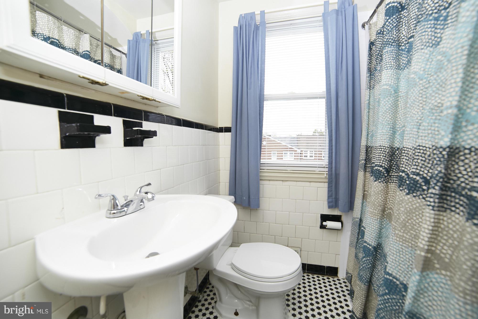 4936 West Hills Road Baltimore, MD 21229 - Photo 9 of 18 a bathroom with a sink toilet and shower