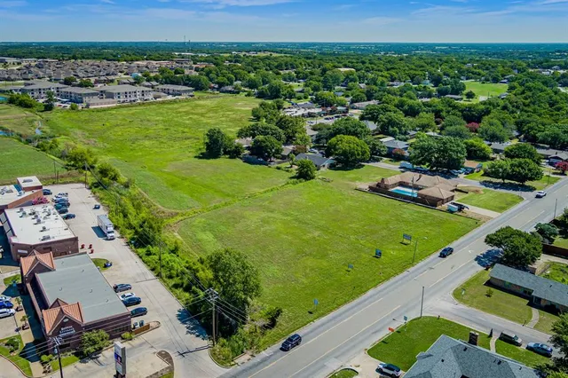 an aerial view of a residential houses with outdoor space