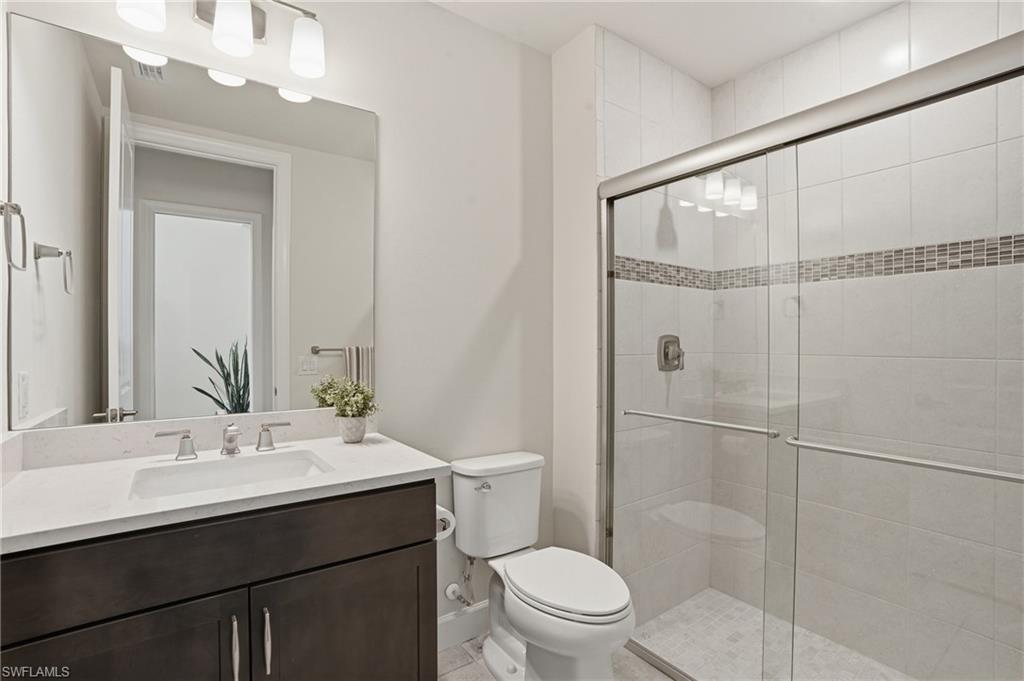 19696 Aqua View Lane Fort Myers, FL 33913 - Photo 22 of 50 a bathroom with a sink mirror toilet and shower