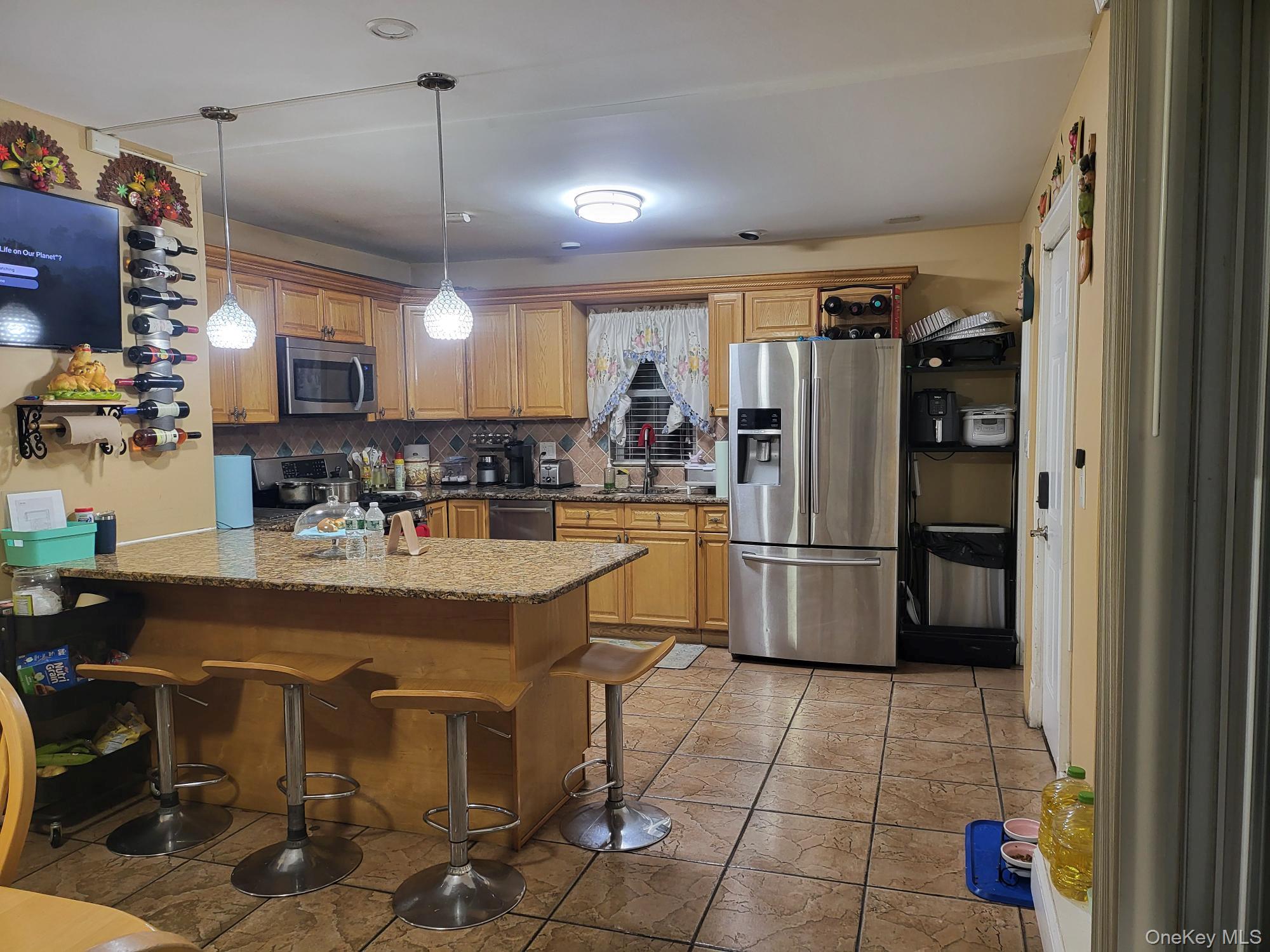 61 Wheeler Road Central Islip, NY 11722 - Photo 12 of 26 a kitchen with stainless steel appliances granite countertop a sink and a refrigerator