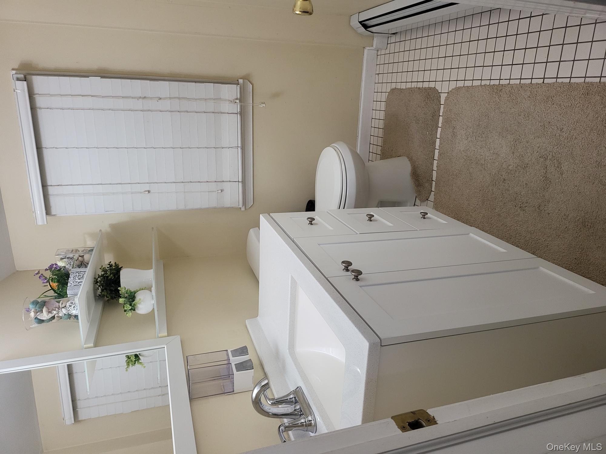 61 Wheeler Road Central Islip, NY 11722 - Photo 13 of 26 a bathroom with a sink toilet and vanity