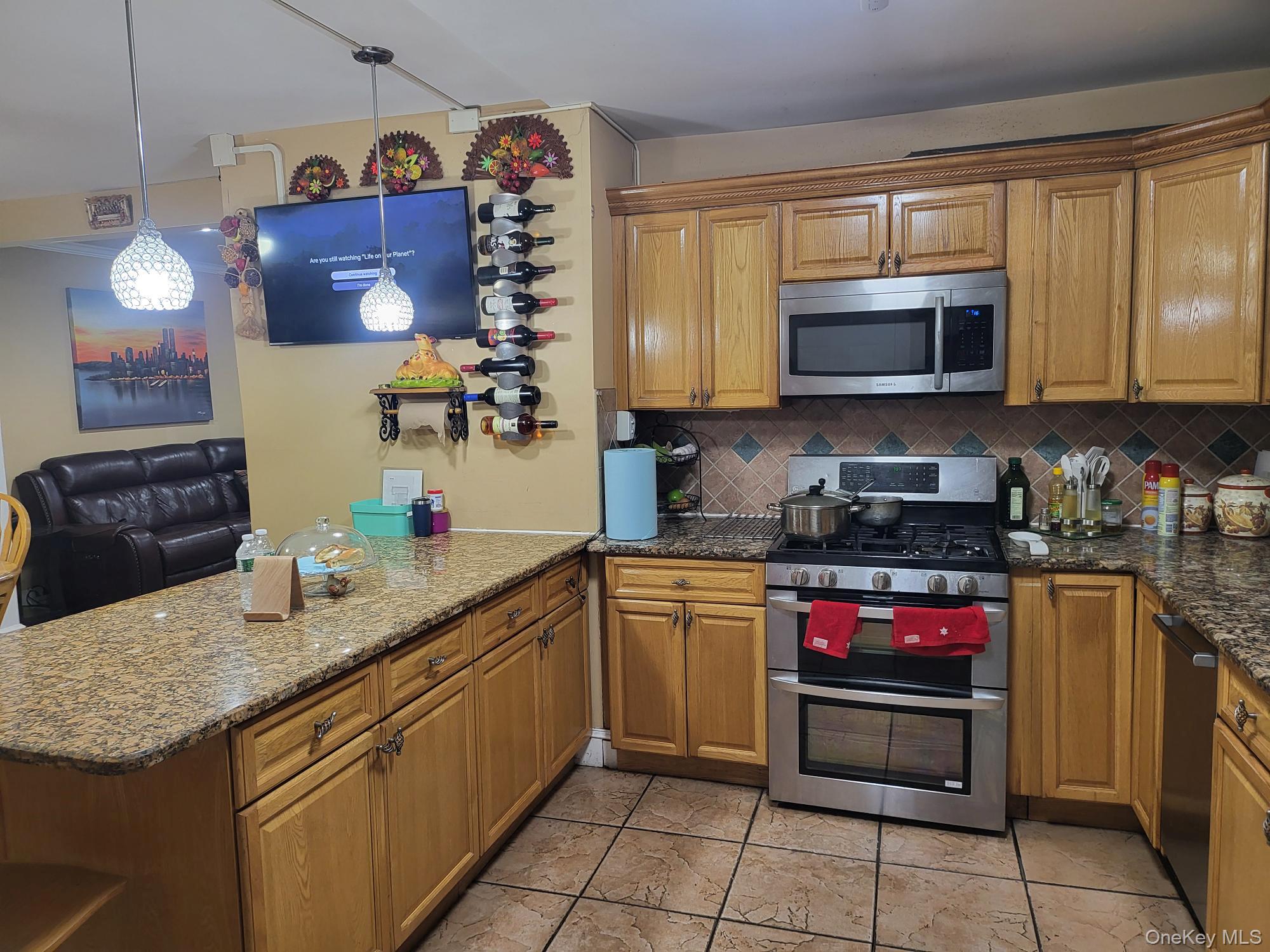 61 Wheeler Road Central Islip, NY 11722 - Photo 14 of 26 a kitchen with stainless steel appliances granite countertop a sink and a stove