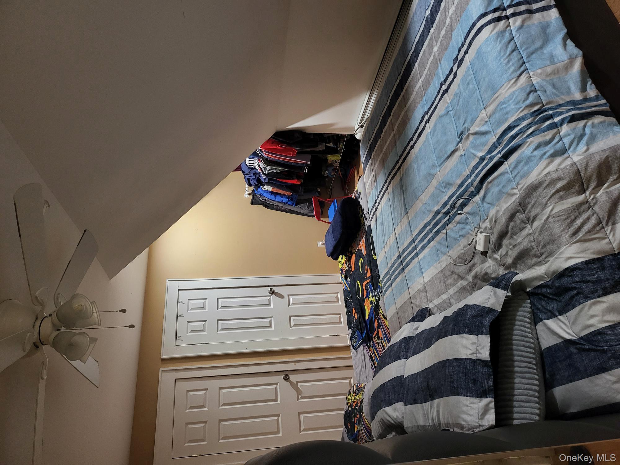 61 Wheeler Road Central Islip, NY 11722 - Photo 17 of 26 a bedroom with a bed and wooden floor