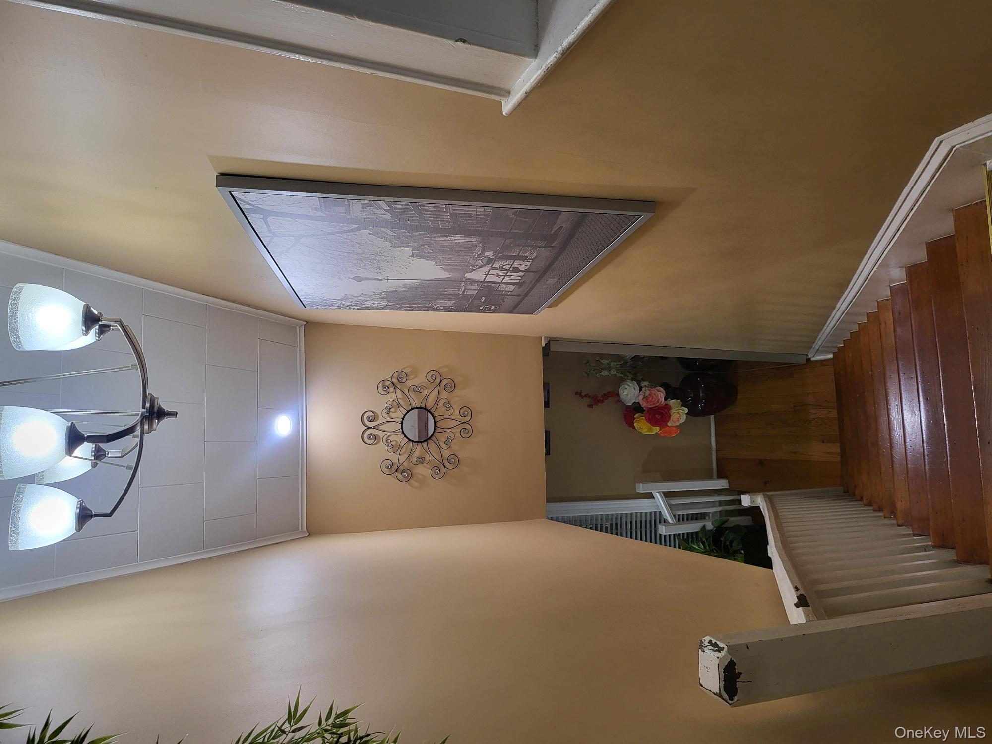 61 Wheeler Road Central Islip, NY 11722 - Photo 20 of 26 a view of a hallway with paintings on the wall and wooden floor