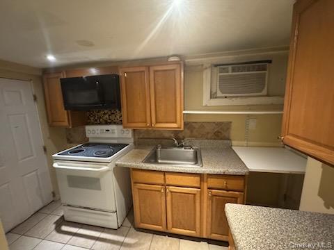61 Wheeler Road Central Islip, NY 11722 - Photo 25 of 26 a kitchen that has a sink and a stove top oven