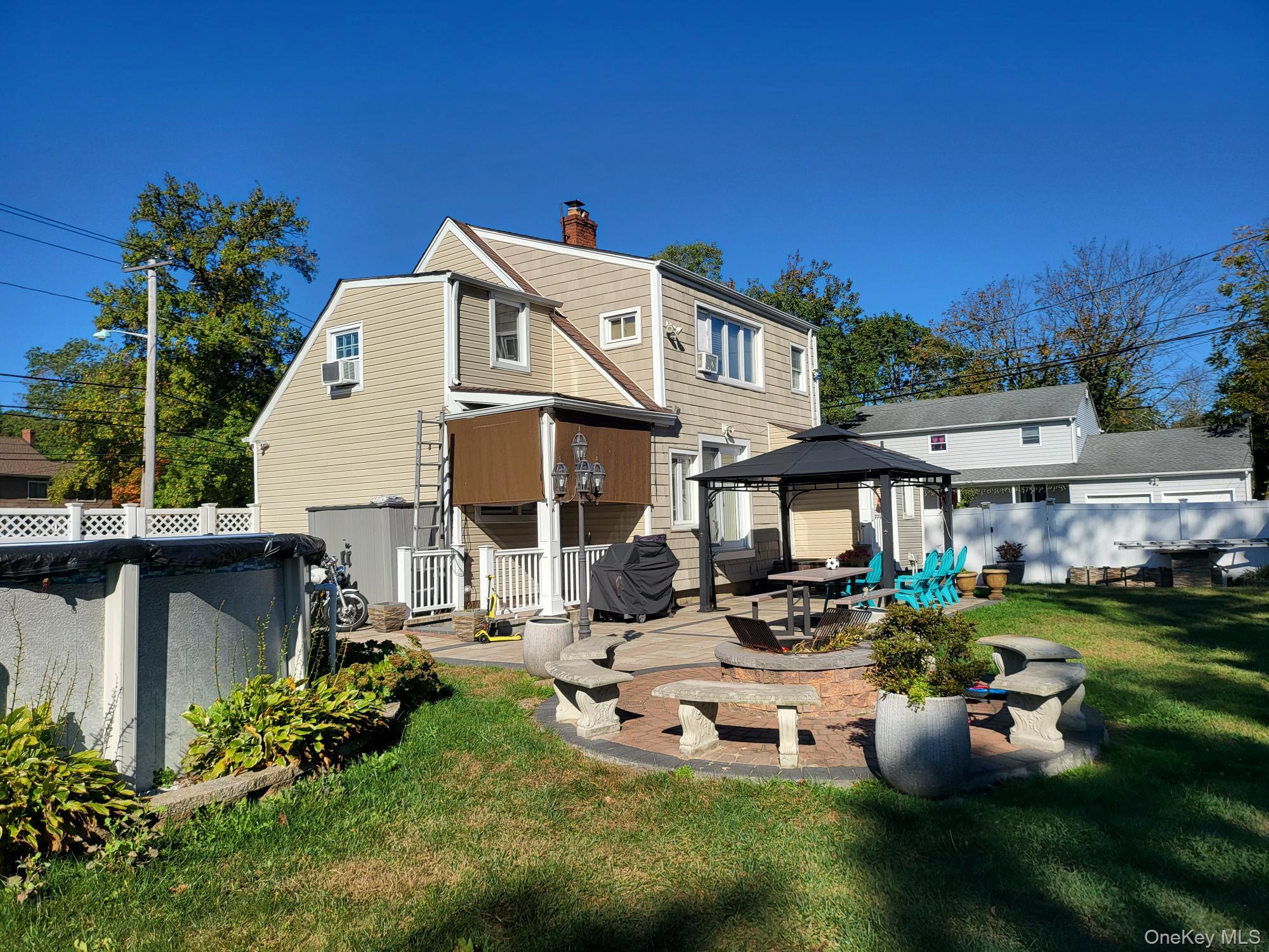 61 Wheeler Road Central Islip, NY 11722 - Photo 5 of 26 a view of a white house with a yard porch and sitting area