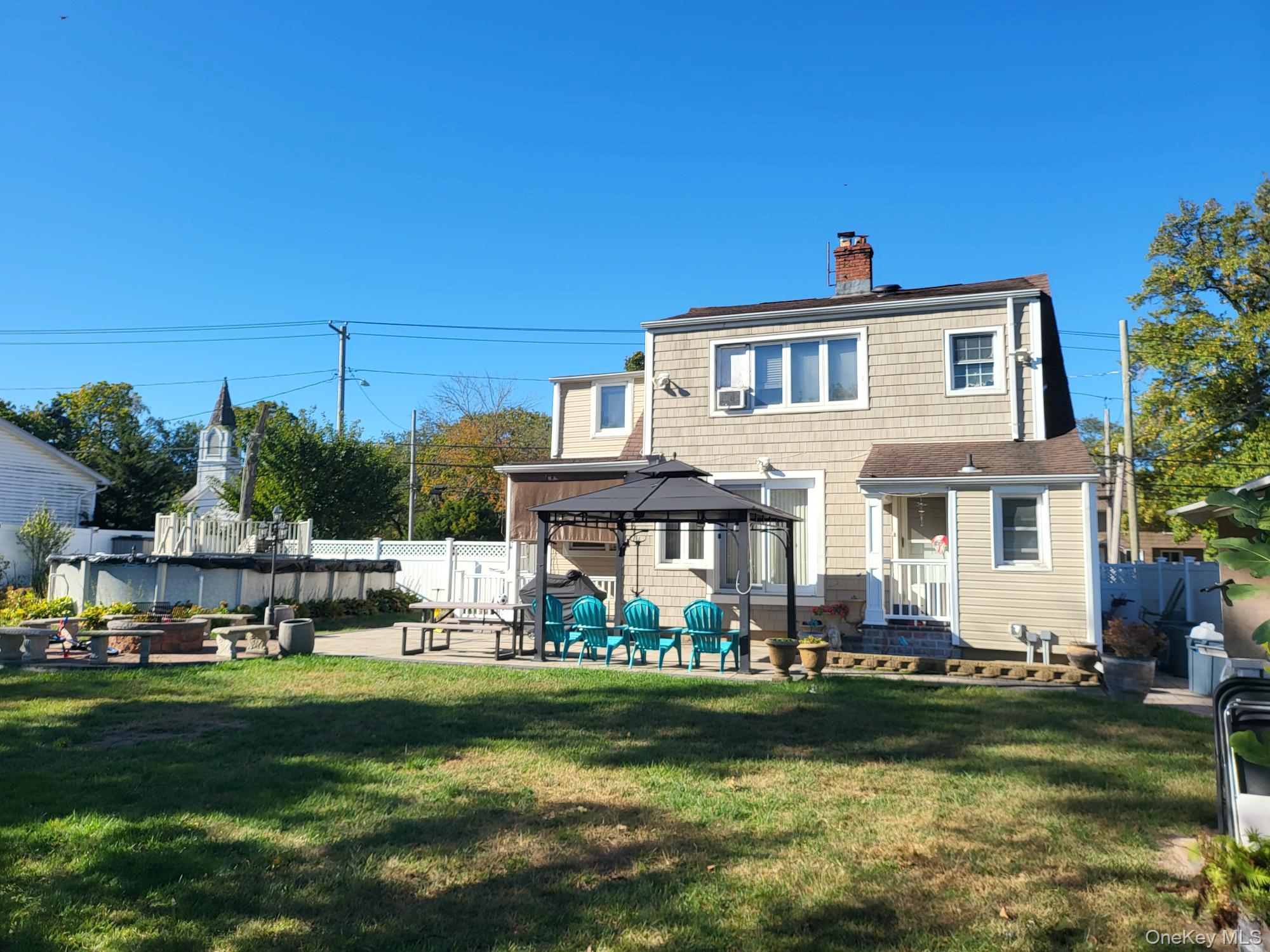 61 Wheeler Road Central Islip, NY 11722 - Photo 6 of 26 a front view of a house with a garden