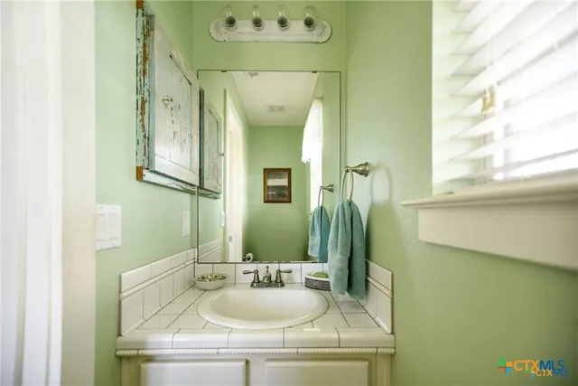 a bathroom with a sink and a mirror