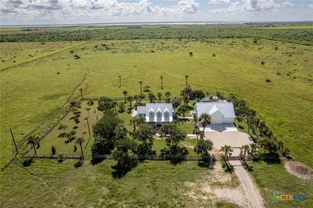 an aerial view of residential house with outdoor space and parking