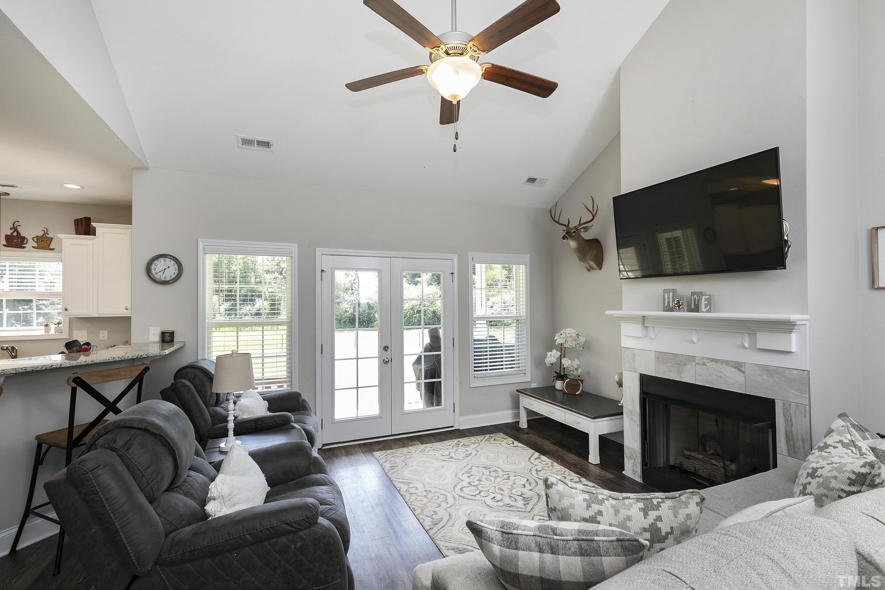 7163 Highway 210 Bunnlevel, NC 28323 - Photo 11 of 54 a living room with furniture a fireplace and a flat screen tv