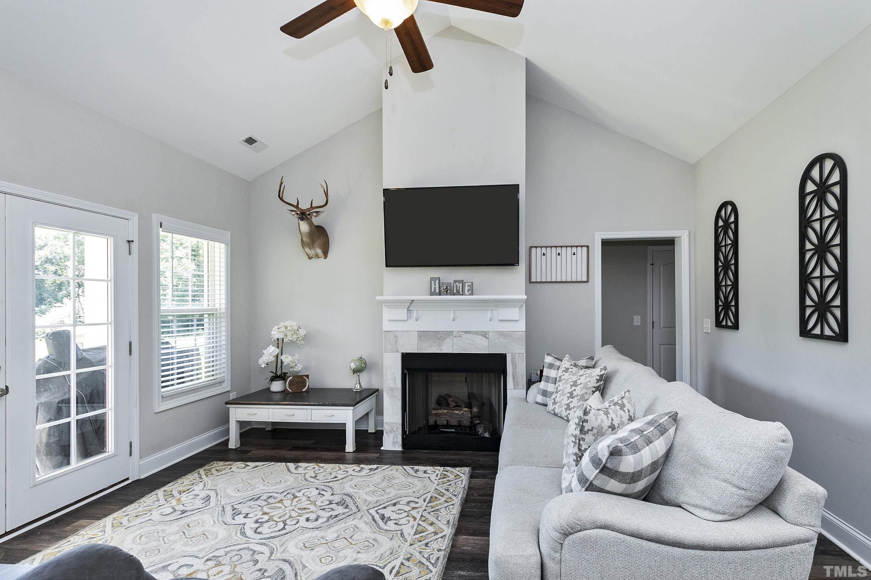 7163 Highway 210 Bunnlevel, NC 28323 - Photo 12 of 54 a living room with furniture a fireplace and a flat screen tv