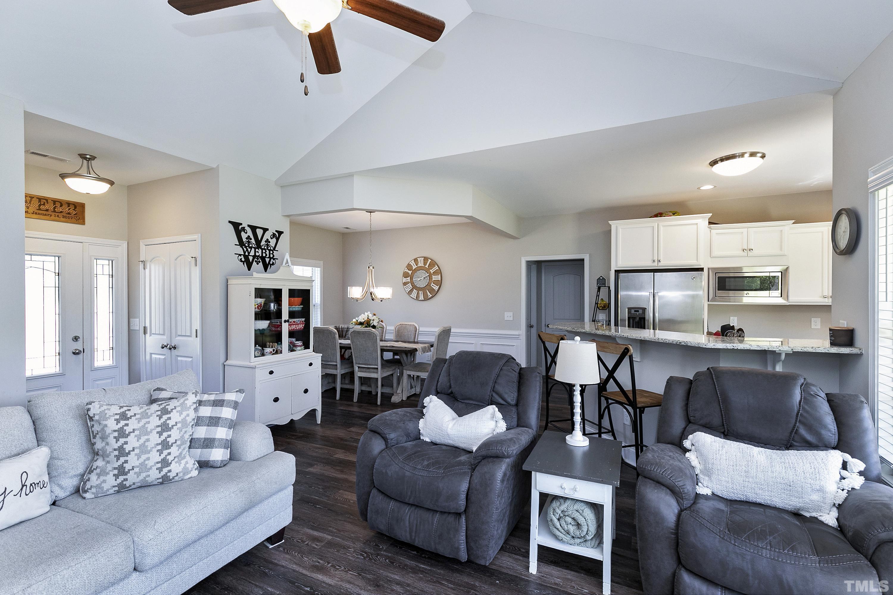 7163 Highway 210 Bunnlevel, NC 28323 - Photo 13 of 54 a living room with furniture kitchen view and a wooden floor