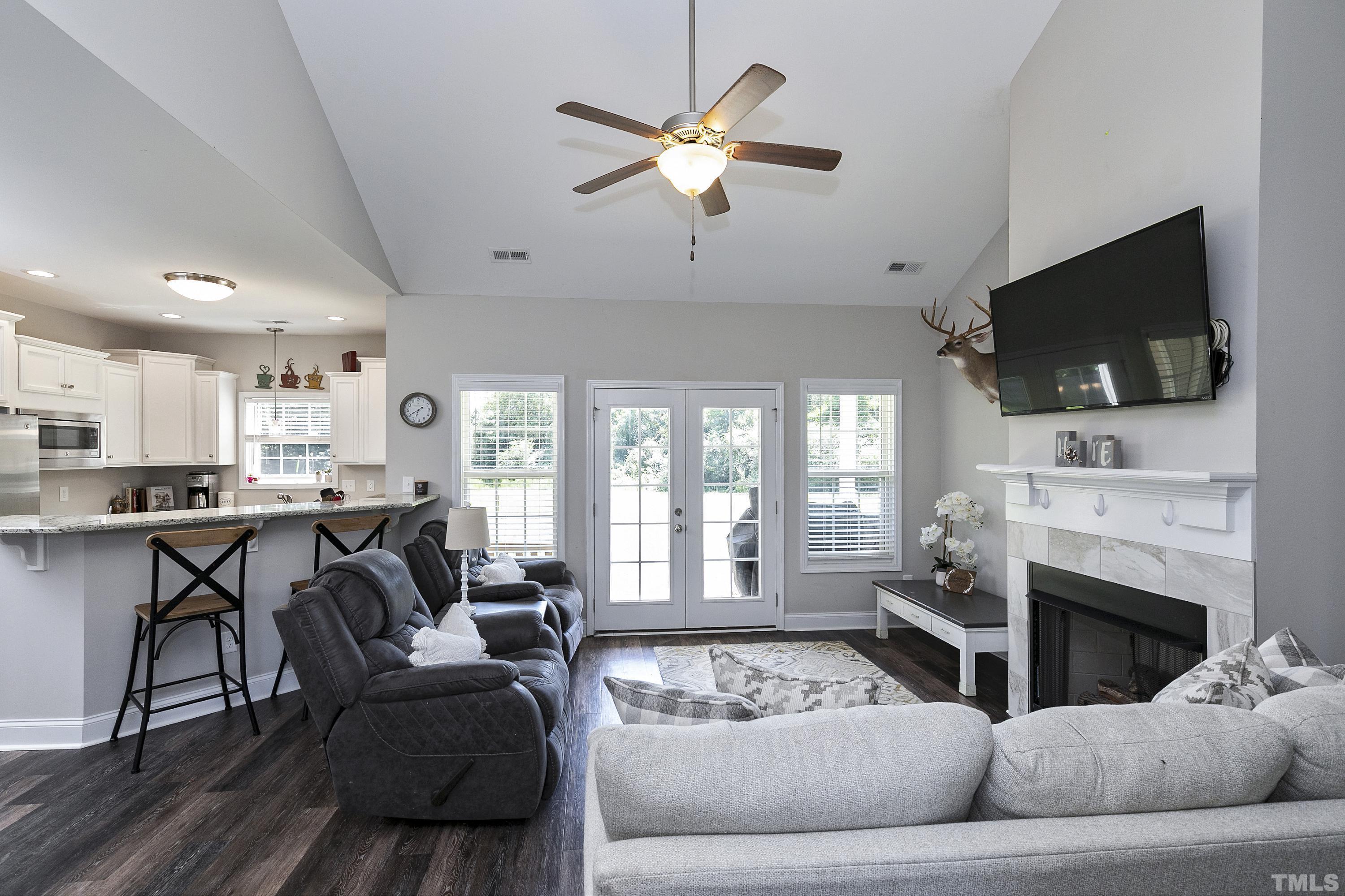 7163 Highway 210 Bunnlevel, NC 28323 - Photo 14 of 54 a living room with furniture a fireplace and a flat screen tv