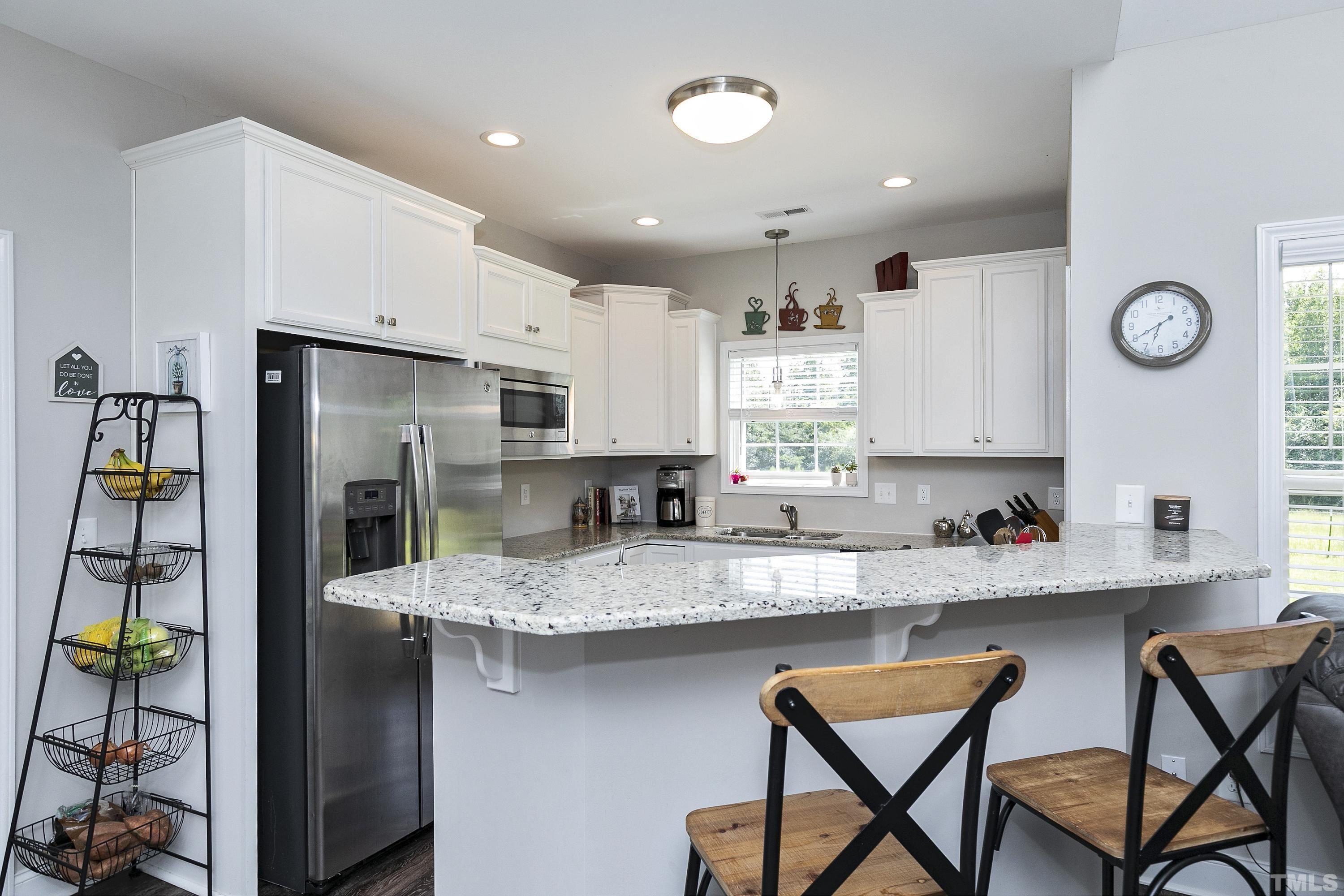 7163 Highway 210 Bunnlevel, NC 28323 - Photo 17 of 54 a kitchen with stainless steel appliances granite countertop a refrigerator and a stove top oven