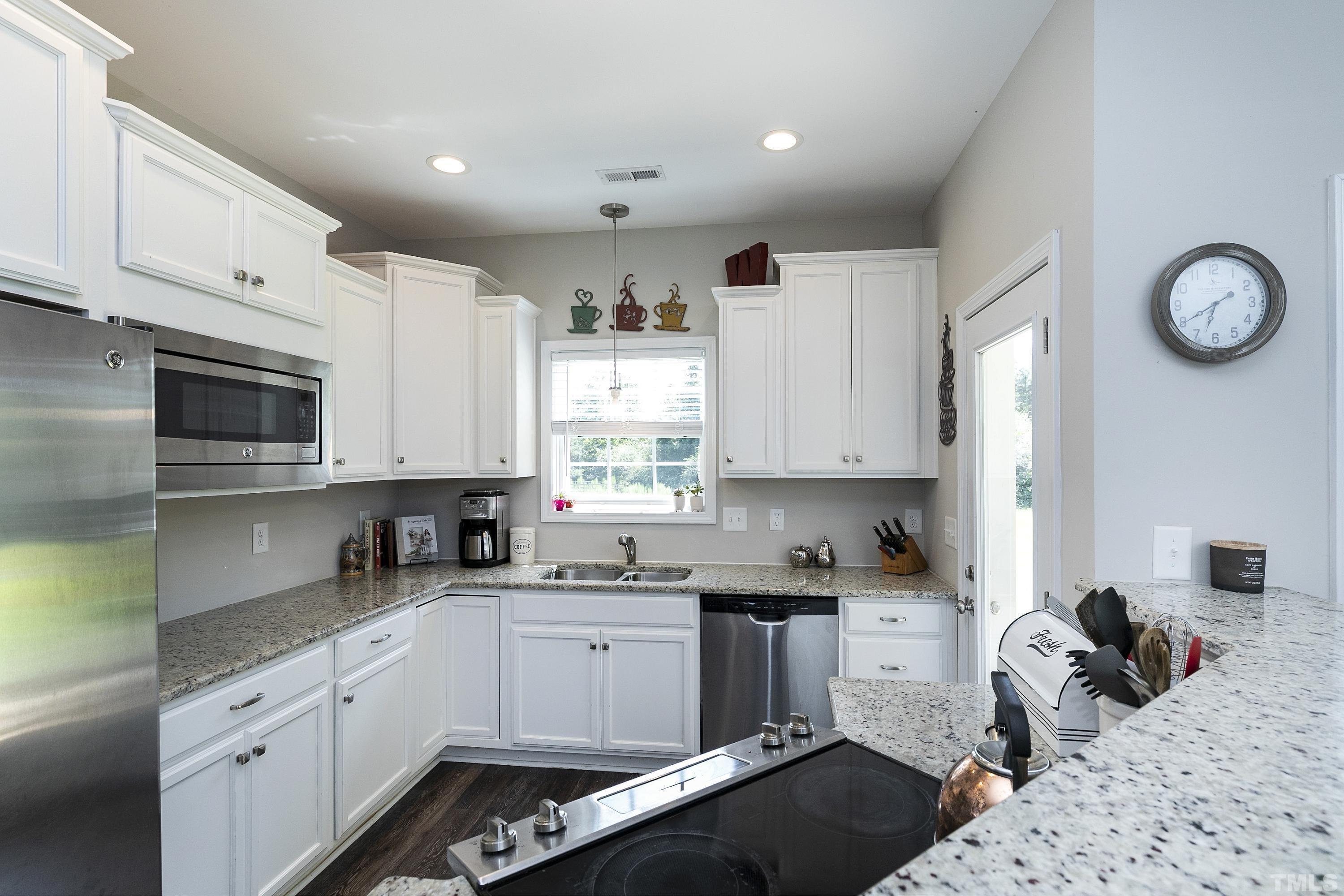 7163 Highway 210 Bunnlevel, NC 28323 - Photo 19 of 54 a kitchen with granite countertop a sink dishwasher stove and cabinets