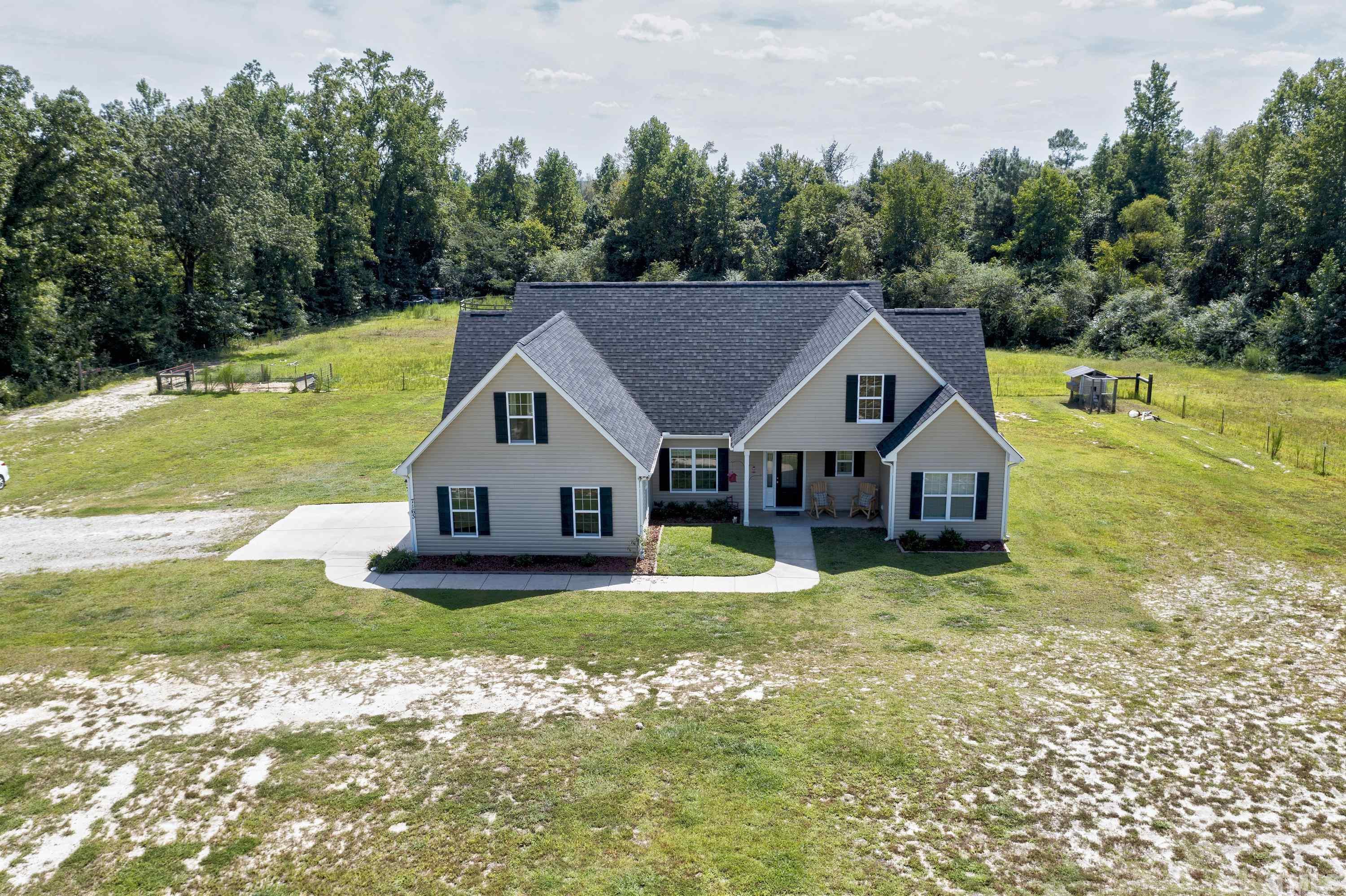 7163 Highway 210 Bunnlevel, NC 28323 - Photo 2 of 54 a aerial view of a house next to a big yard and large trees
