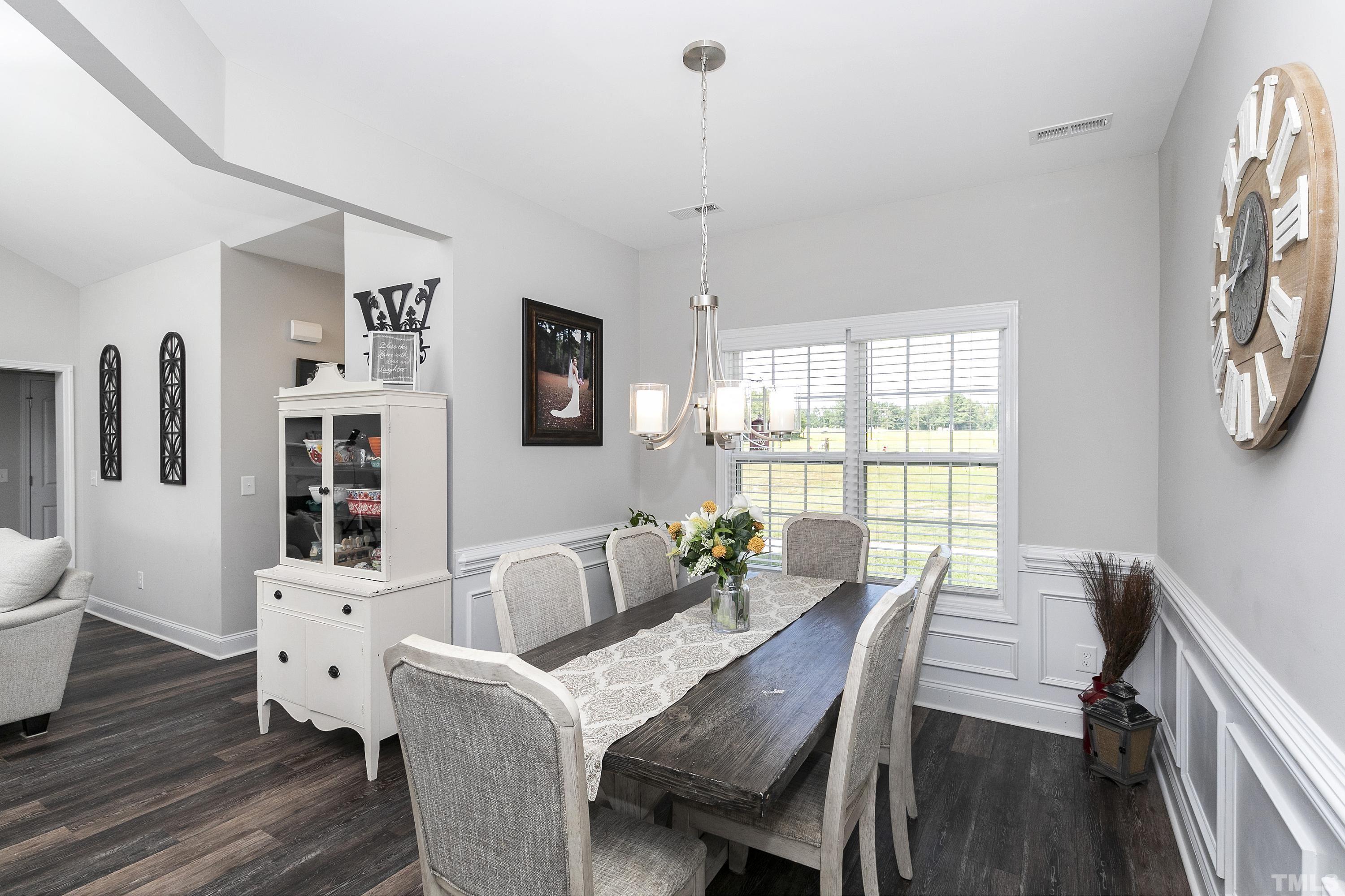 7163 Highway 210 Bunnlevel, NC 28323 - Photo 21 of 54 a view of a dining room with furniture window and wooden floor