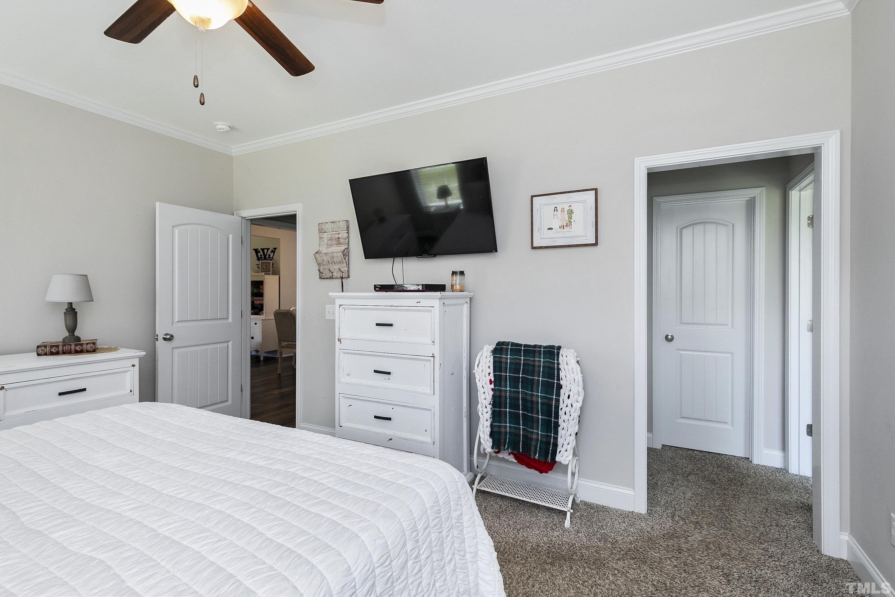 7163 Highway 210 Bunnlevel, NC 28323 - Photo 24 of 54 a bedroom with a bed and a flat screen tv