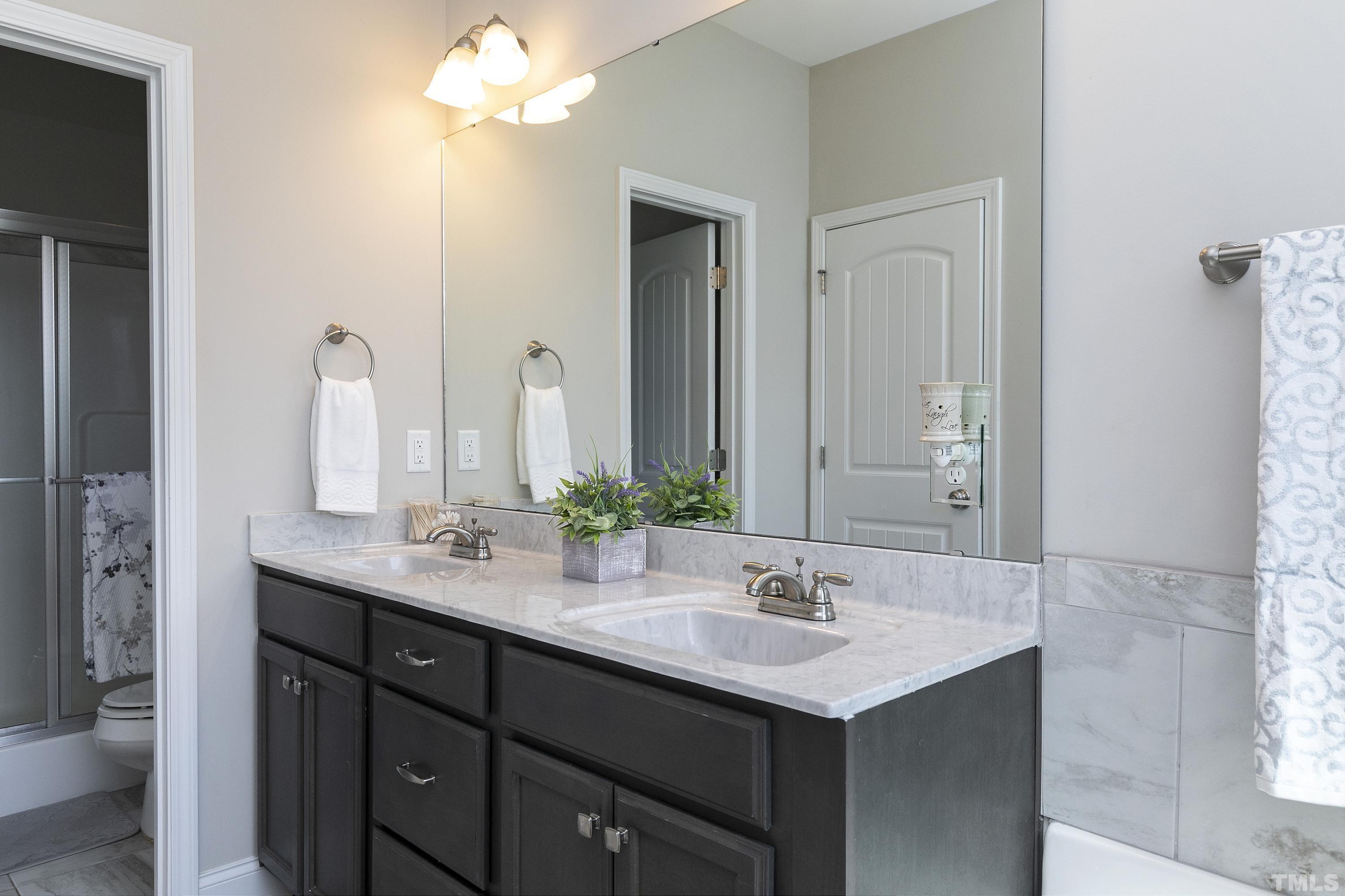 7163 Highway 210 Bunnlevel, NC 28323 - Photo 27 of 54 a bathroom with a sink double vanity and a mirror