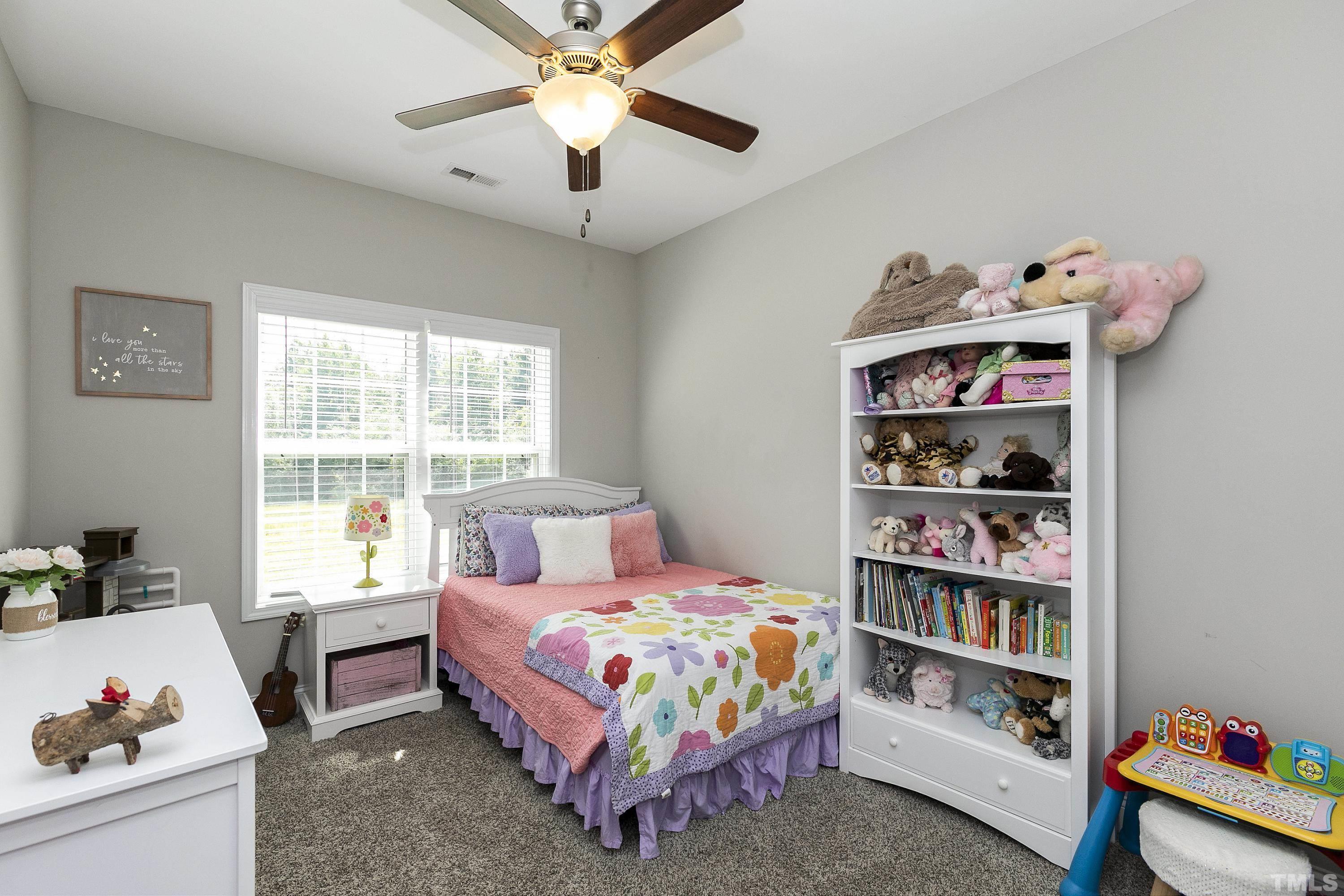 7163 Highway 210 Bunnlevel, NC 28323 - Photo 30 of 54 a bedroom with a bed and a window