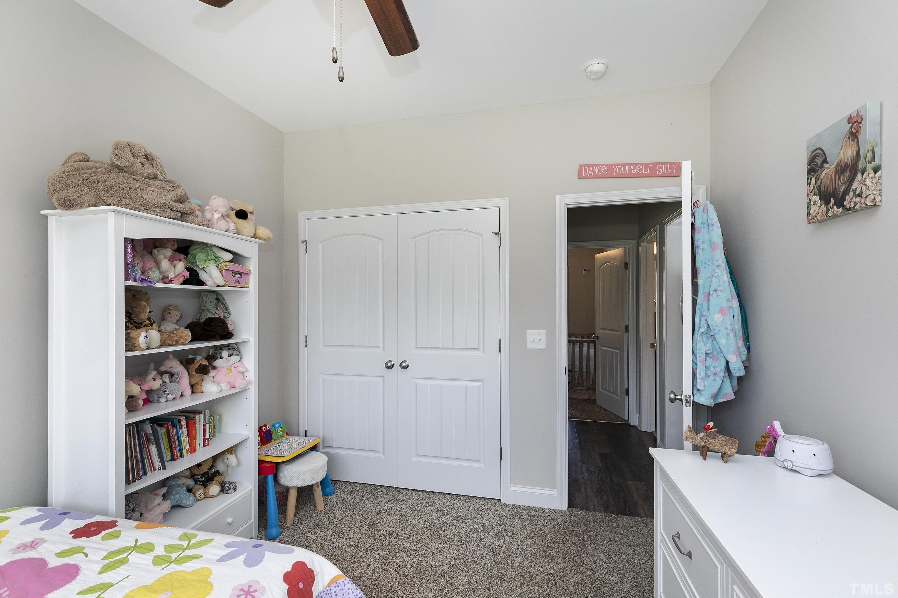 7163 Highway 210 Bunnlevel, NC 28323 - Photo 31 of 54 a bedroom with a bed and a book shelf