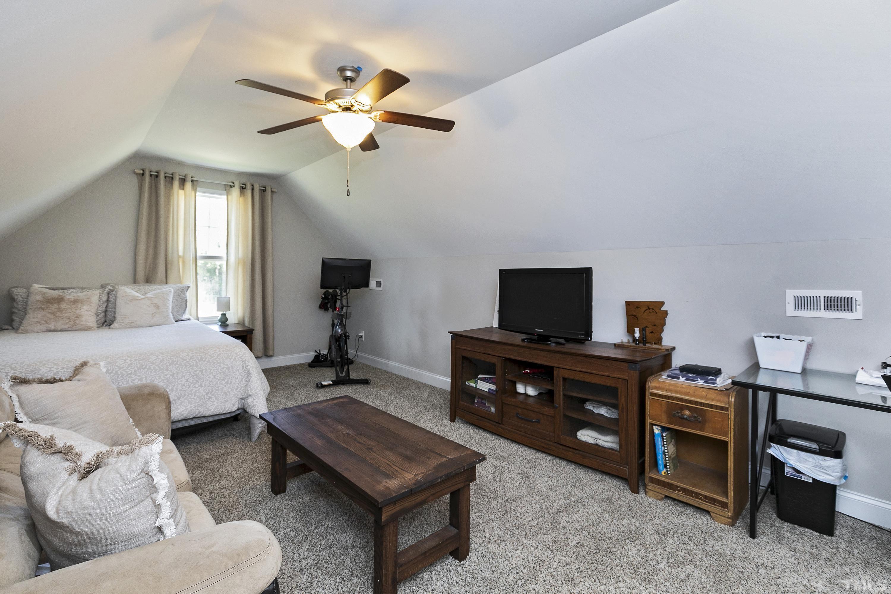 7163 Highway 210 Bunnlevel, NC 28323 - Photo 35 of 54 a bedroom with furniture and a flat screen tv