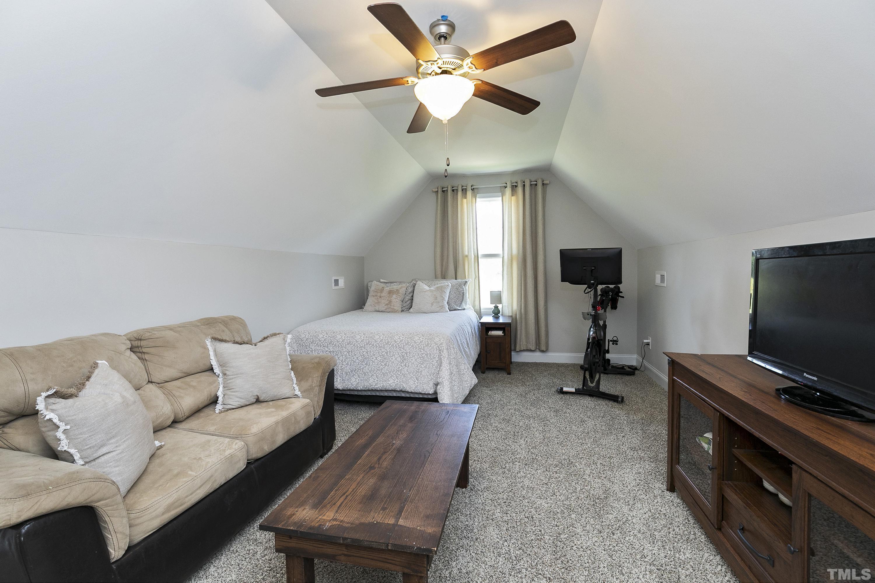 7163 Highway 210 Bunnlevel, NC 28323 - Photo 36 of 54 a bedroom with furniture and a flat screen tv