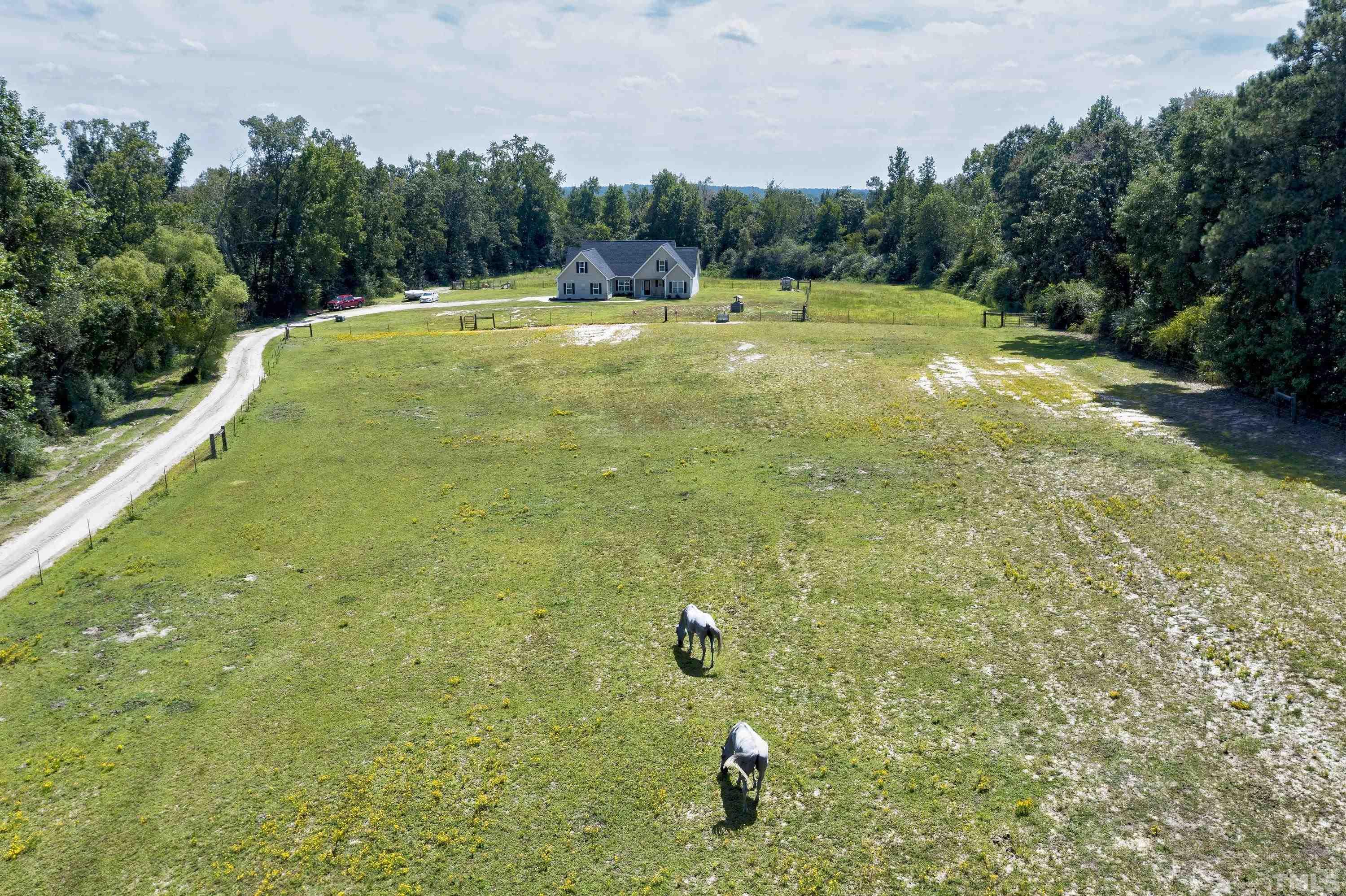 7163 Highway 210 Bunnlevel, NC 28323 - Photo 49 of 54 a view of a big yard with an outdoor space and seating area