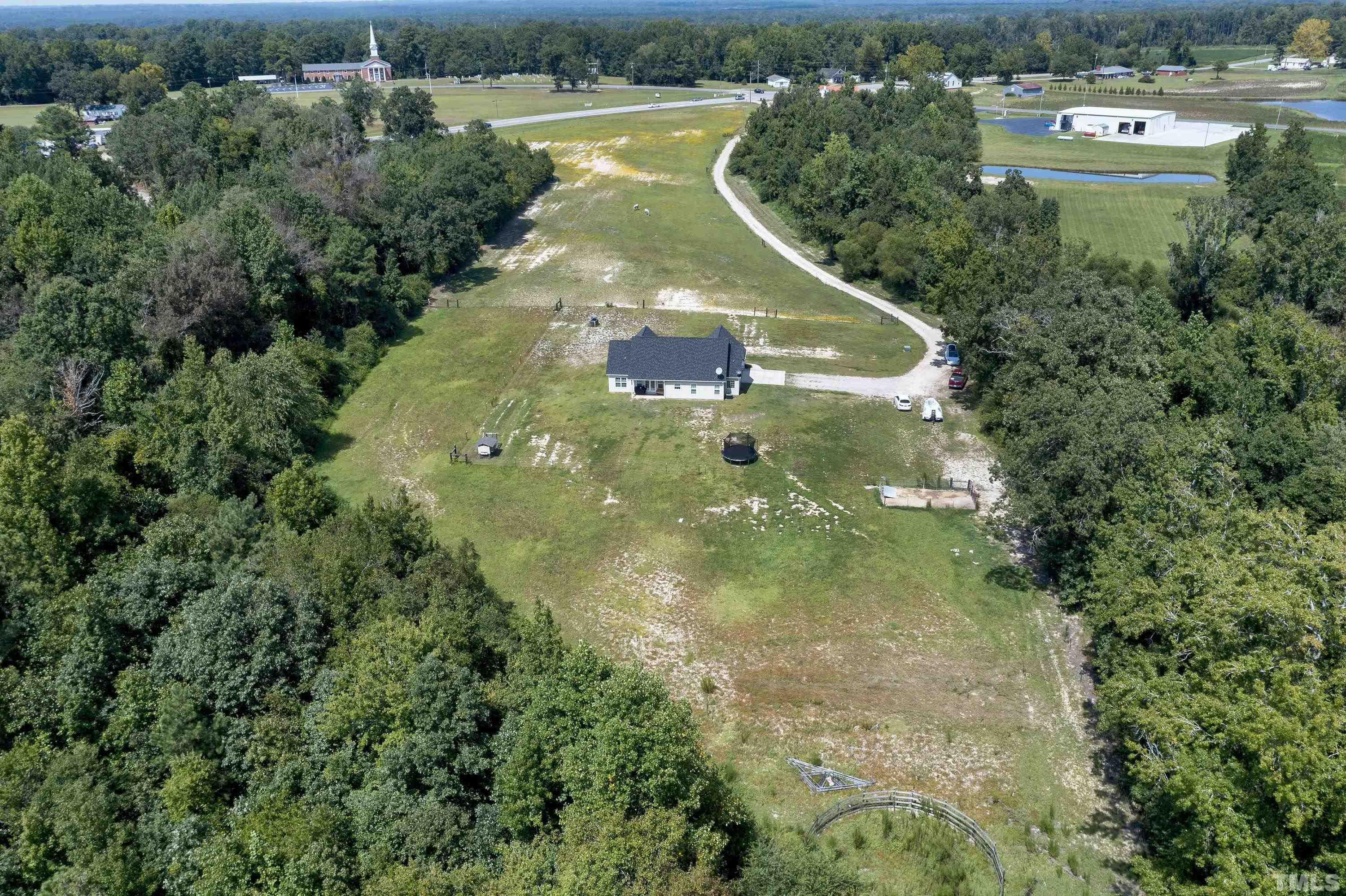 7163 Highway 210 Bunnlevel, NC 28323 - Photo 51 of 54 an aerial view of residential houses with outdoor space and trees all around