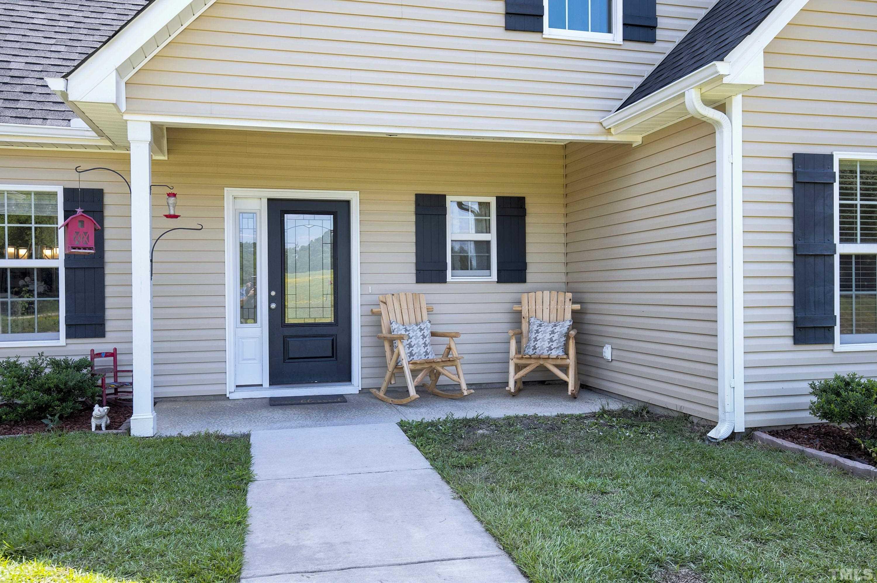 7163 Highway 210 Bunnlevel, NC 28323 - Photo 9 of 54 a front view of a house with a garden