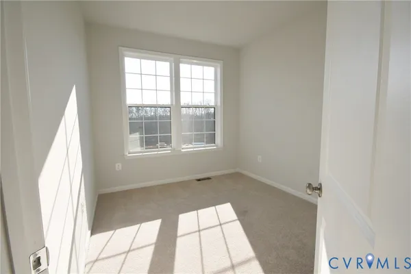 a view of an empty room and a window
