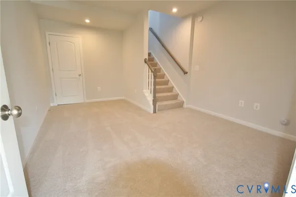 a view of an empty room with stairs