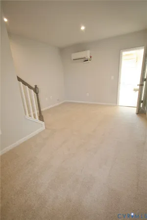 an empty room with a window and stairs