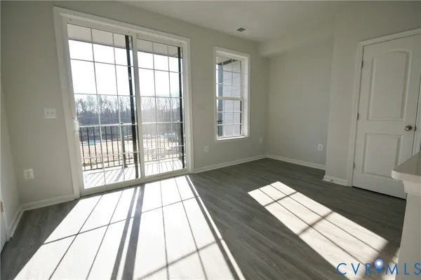 a view of wooden floor in a room next to a window