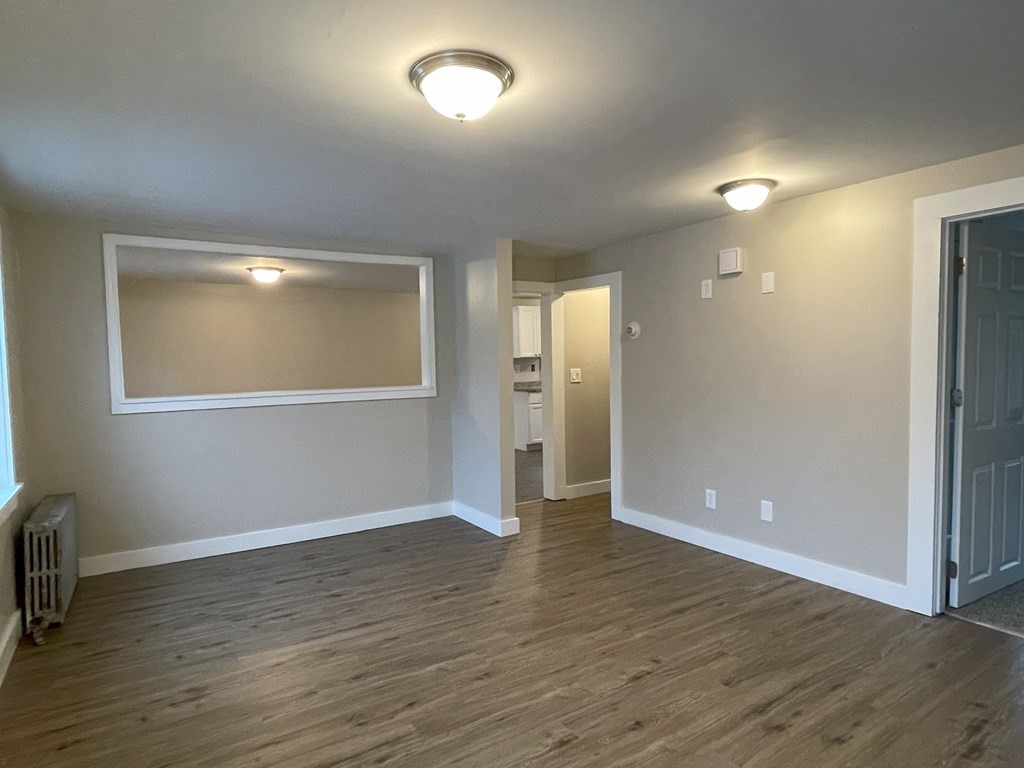 87 Cohasset Road Wareham, MA 02532 - Photo 7 of 16 an empty room with wooden floor and windows