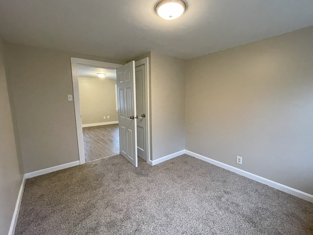 87 Cohasset Road Wareham, MA 02532 - Photo 9 of 16 an empty room with an entrance to other room