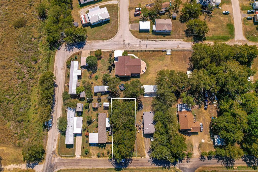 an aerial view of residential houses with outdoor space and parking