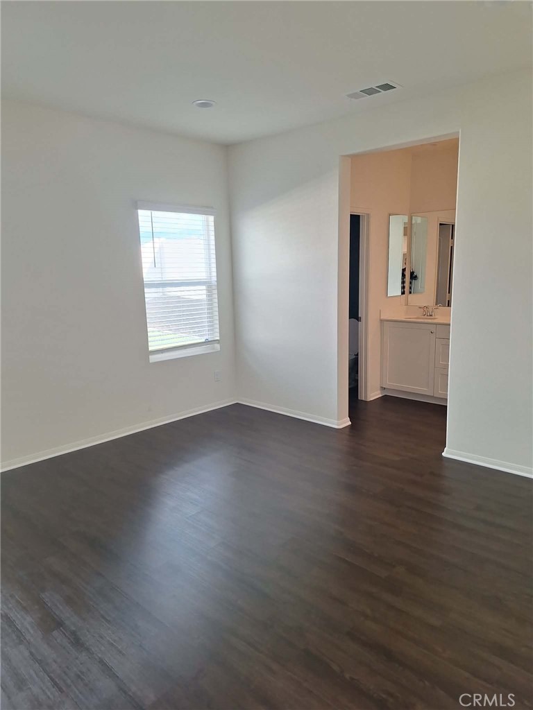 35170 Webb Place Beaumont, CA 92223 - Photo 11 of 21 an empty room with wooden floor and a window