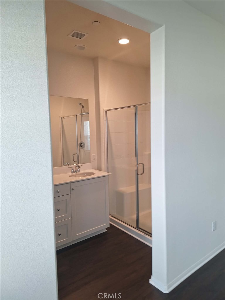 35170 Webb Place Beaumont, CA 92223 - Photo 12 of 21 a bathroom with a sink a mirror and a shower